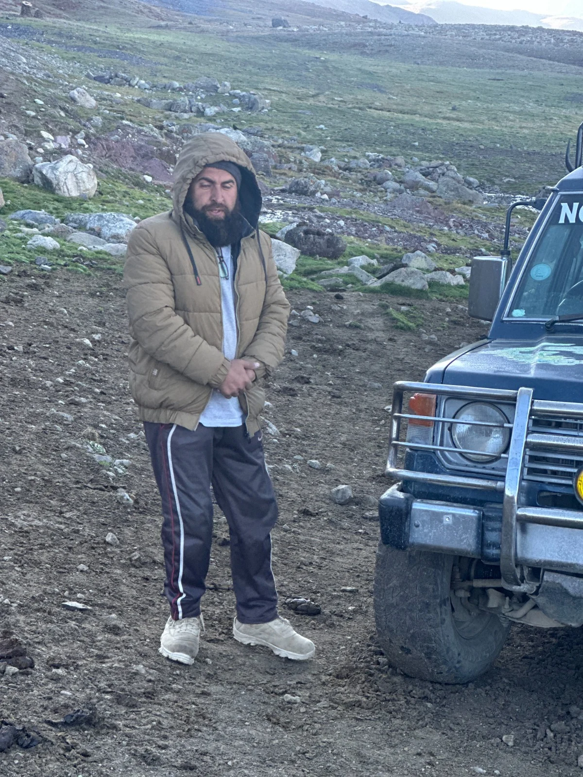 Abdullah beside his Pajero, Ameera, on a rocky mountain track
