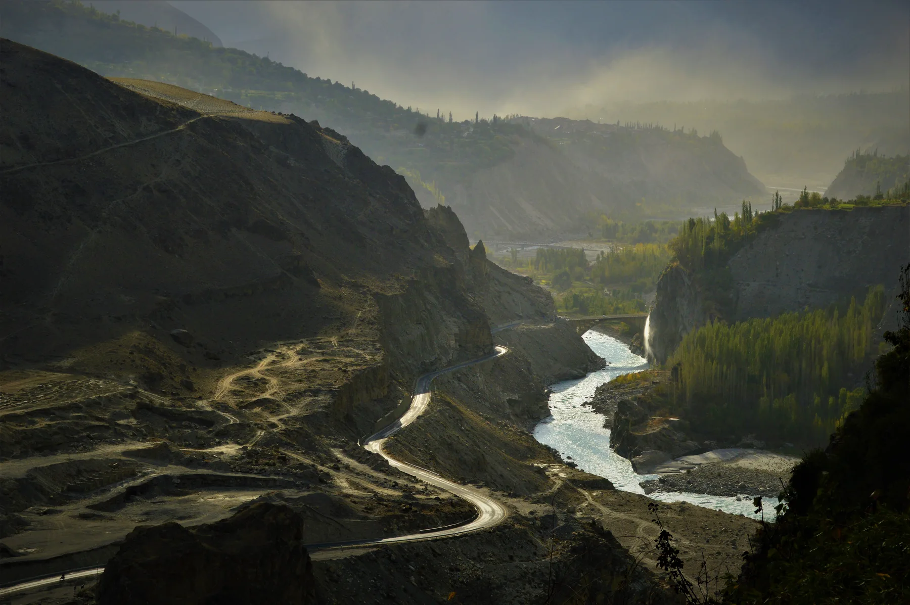 The Karakoram Highway winding beneath high mountain walls